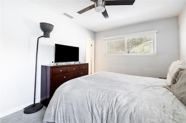 bedroom featuring ceiling fan and carpet