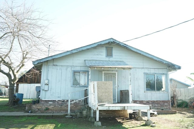 rear view of house featuring a lawn