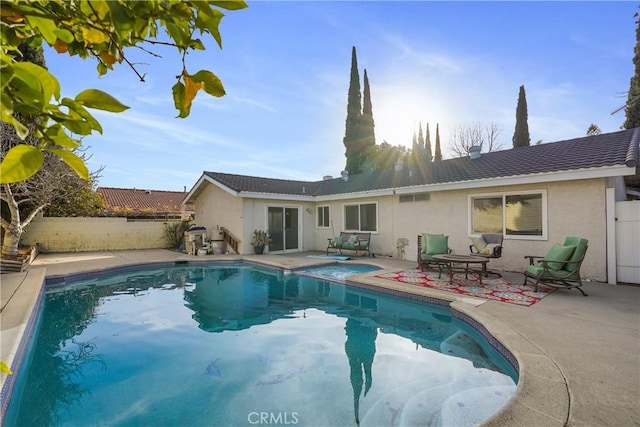 back of house featuring a fenced in pool and a patio