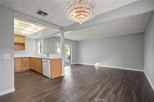 kitchen with dark wood-type flooring, white dishwasher, a notable chandelier, light brown cabinetry, and kitchen peninsula