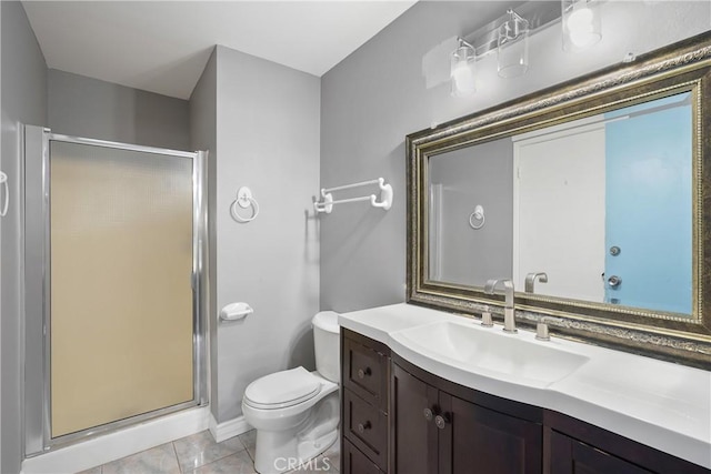 bathroom with vanity, tile patterned flooring, toilet, and walk in shower