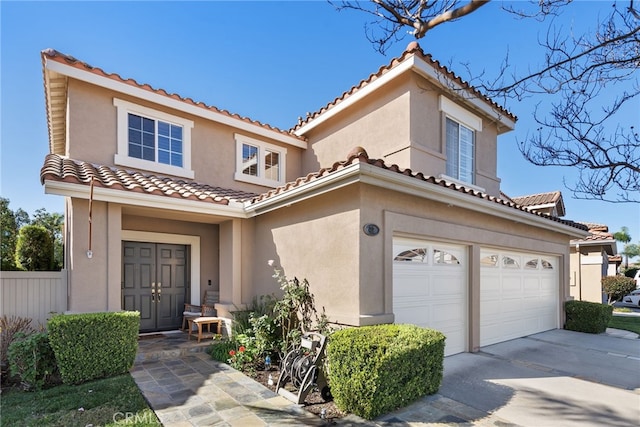 mediterranean / spanish house featuring a garage