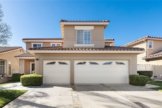 mediterranean / spanish-style house with a garage