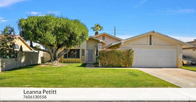 view of front of property featuring a garage and a front lawn