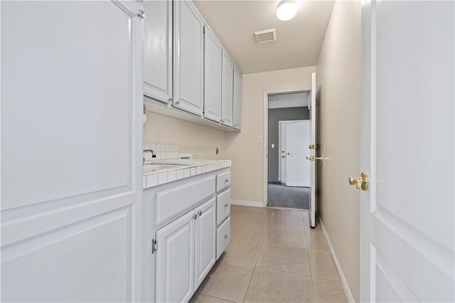 laundry area featuring light tile patterned floors