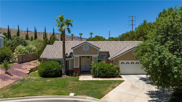 ranch-style house with a garage and a front yard