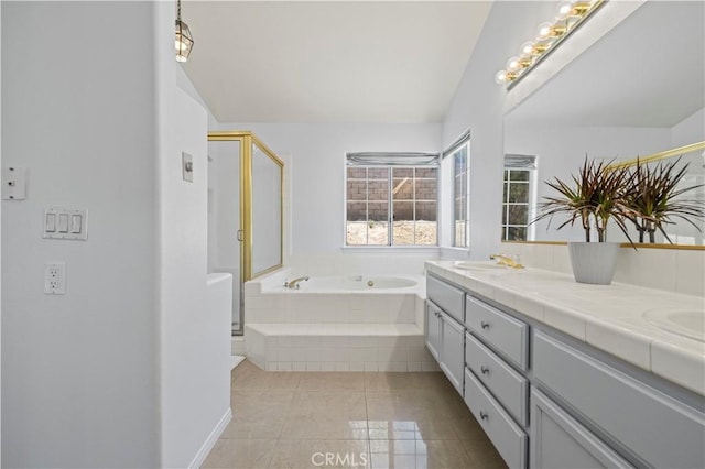 bathroom featuring plus walk in shower, vanity, and tile patterned floors