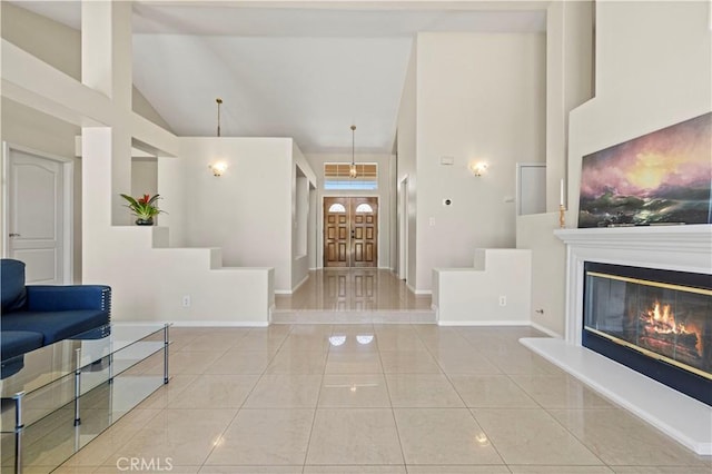 tiled foyer entrance featuring a towering ceiling