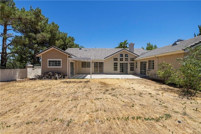 rear view of property featuring a patio