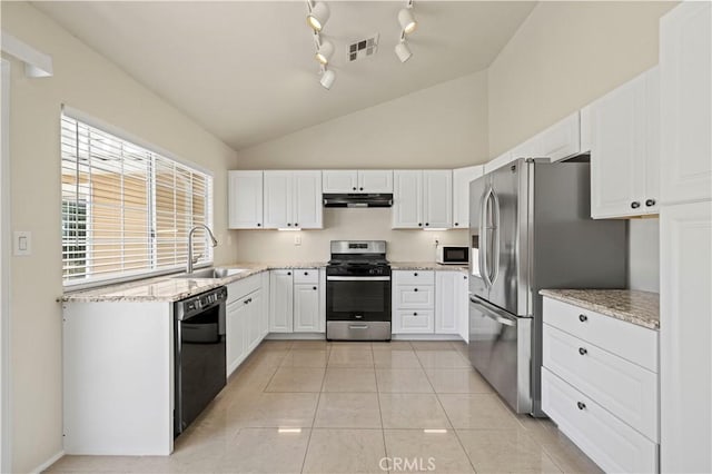 kitchen featuring lofted ceiling, sink, white cabinetry, light tile patterned floors, and stainless steel appliances