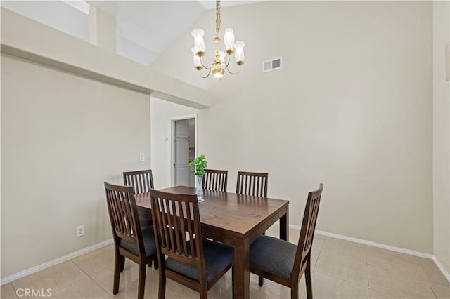 tiled dining room with a notable chandelier and high vaulted ceiling