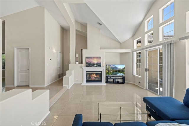 living room featuring a high ceiling and light tile patterned floors