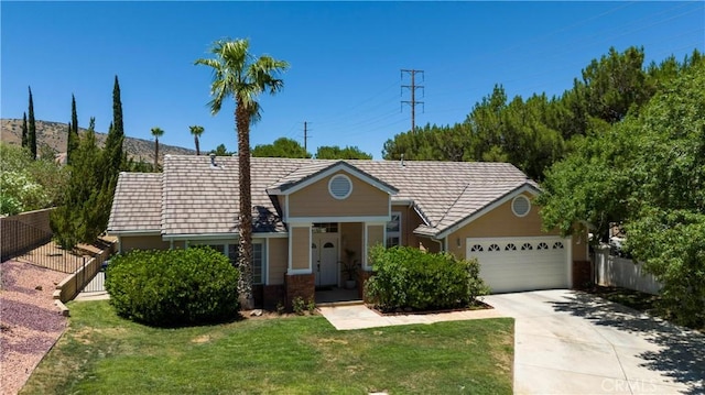 ranch-style home featuring a garage and a front lawn