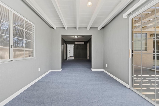 corridor featuring beam ceiling, a wall mounted AC, and dark carpet