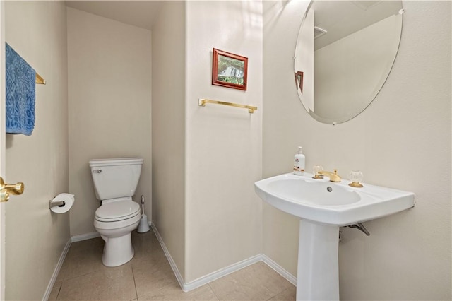 bathroom featuring toilet and tile patterned flooring