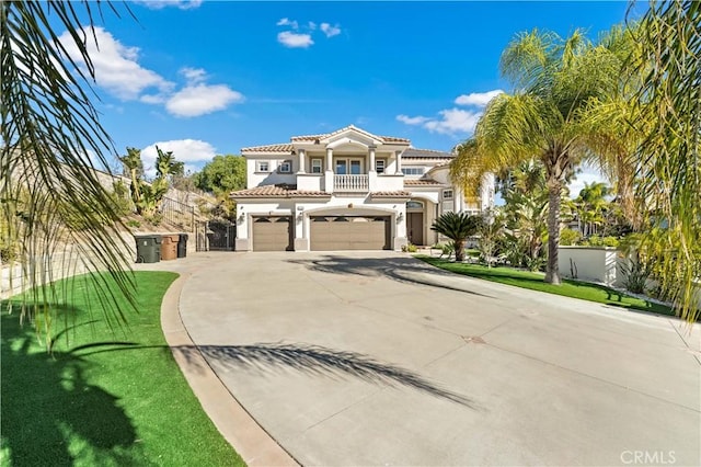 mediterranean / spanish-style house with a garage, a front lawn, and a balcony