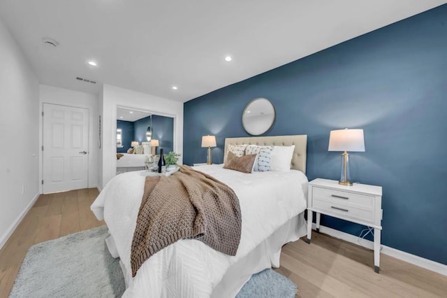 bedroom featuring a closet and light hardwood / wood-style flooring