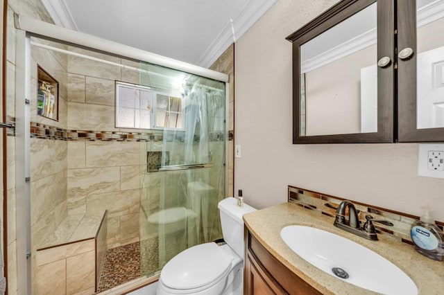 bathroom featuring ornamental molding, toilet, a shower with shower door, and vanity