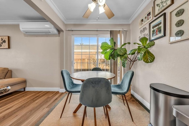 dining space with crown molding, a wall unit AC, ceiling fan, and light wood-type flooring