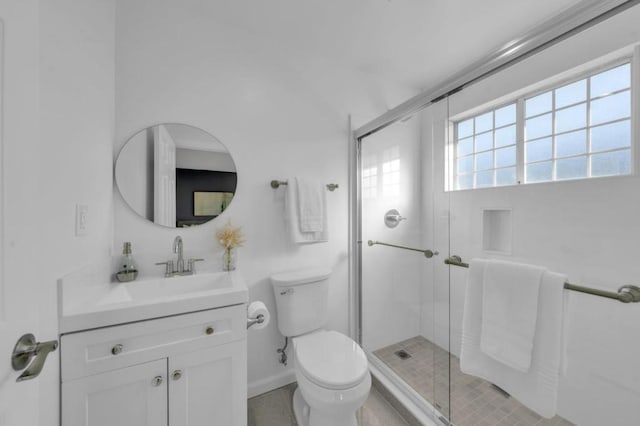 bathroom featuring walk in shower, vanity, and toilet