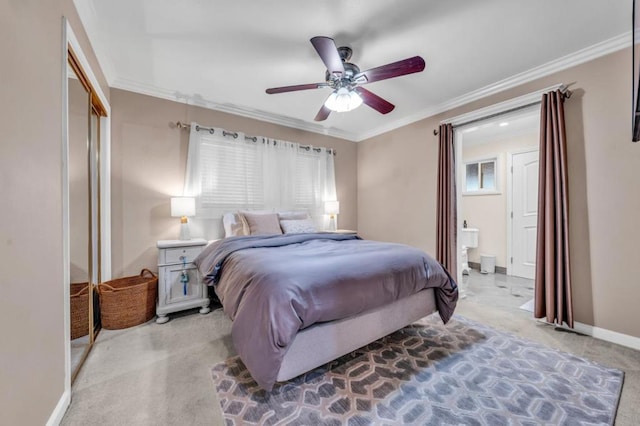 carpeted bedroom featuring ceiling fan, ornamental molding, connected bathroom, and a closet