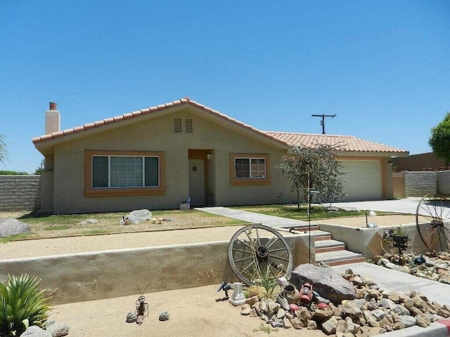 ranch-style home featuring a garage