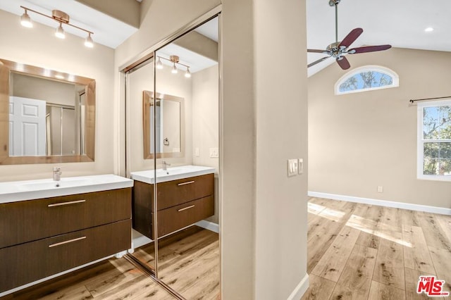 bathroom featuring lofted ceiling, vanity, wood-type flooring, and ceiling fan