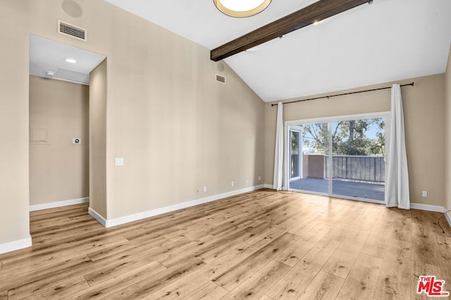 unfurnished room with vaulted ceiling with beams and light wood-type flooring