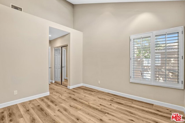 unfurnished room with light wood-type flooring