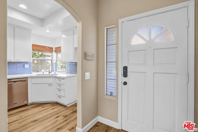 entrance foyer featuring sink and light hardwood / wood-style flooring