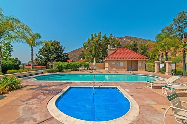 view of pool with a patio and a mountain view