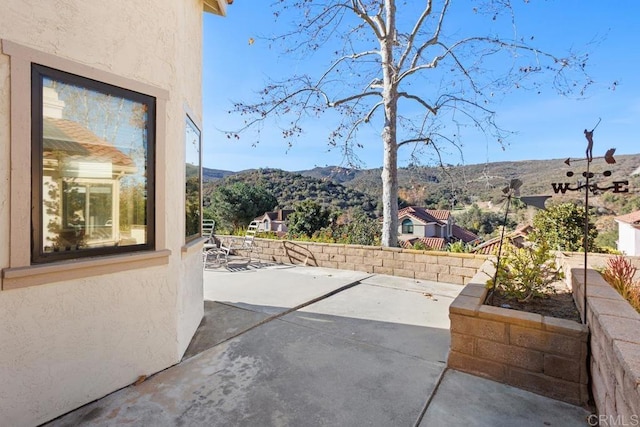 view of patio / terrace featuring a mountain view