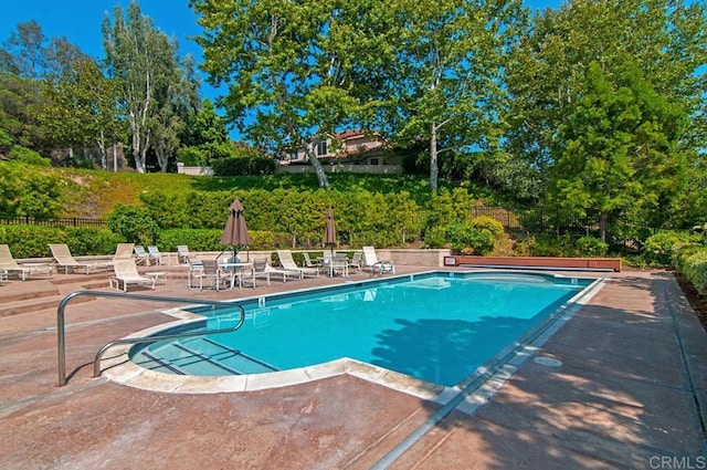 view of swimming pool with a patio area