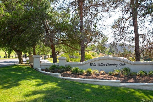 community / neighborhood sign with a yard