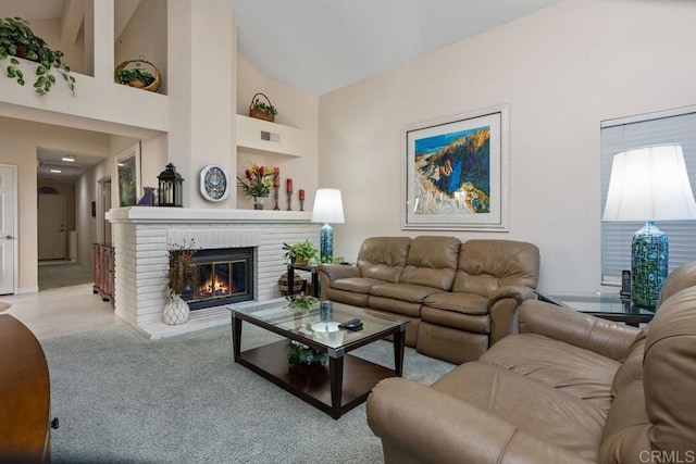 living room with a fireplace and high vaulted ceiling