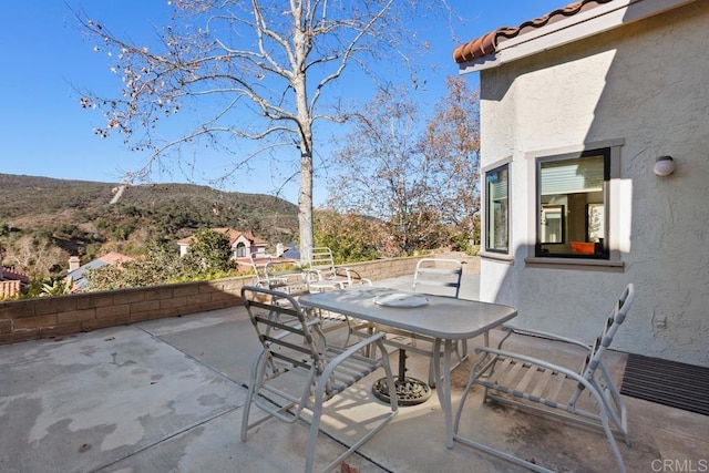 view of patio / terrace featuring a mountain view