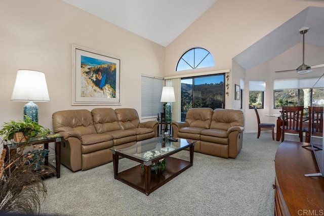 carpeted living room featuring ceiling fan and high vaulted ceiling