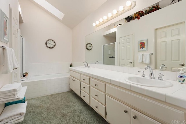 bathroom featuring vanity, lofted ceiling with skylight, and separate shower and tub