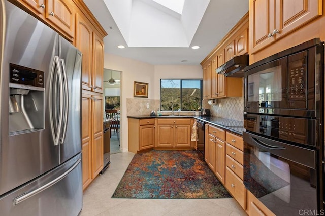 kitchen featuring light tile patterned flooring, sink, tasteful backsplash, a skylight, and black appliances