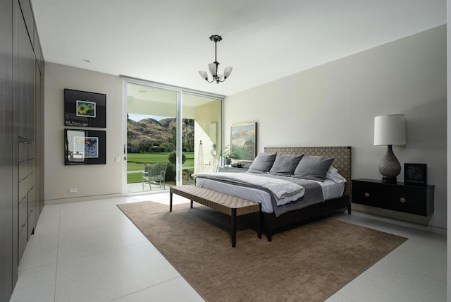 bedroom with a notable chandelier, floor to ceiling windows, a mountain view, and access to exterior