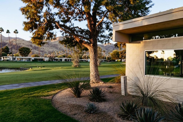 view of home's community with a lawn and a water and mountain view