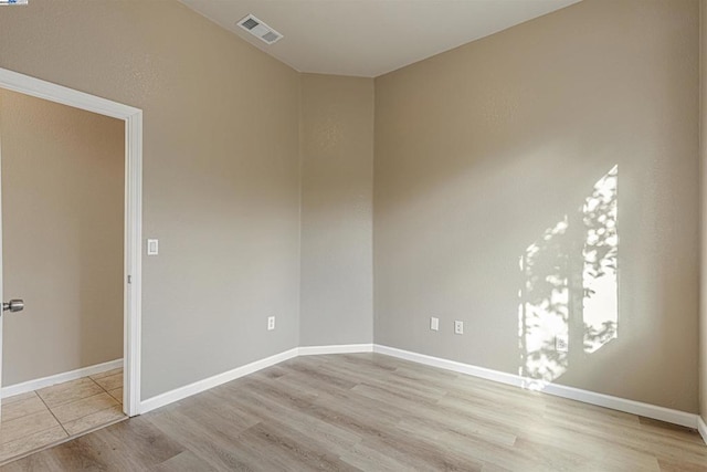 spare room featuring light hardwood / wood-style flooring