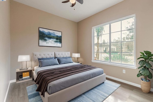 bedroom with ceiling fan and wood-type flooring