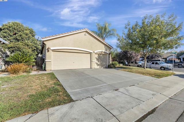 view of side of home featuring a garage and a lawn