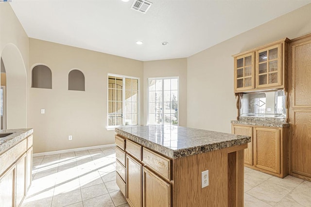 kitchen featuring light tile patterned floors and a center island