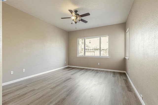 unfurnished room with ceiling fan and light wood-type flooring