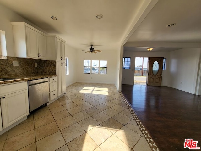 kitchen featuring white cabinetry, stainless steel dishwasher, ceiling fan, and light tile patterned floors