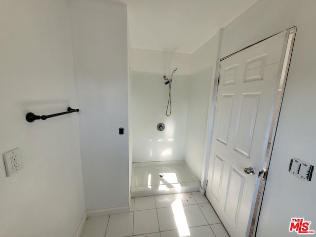 bathroom with walk in shower and tile patterned flooring