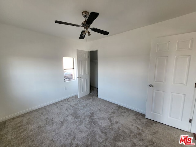 unfurnished bedroom with light carpet, a closet, and ceiling fan