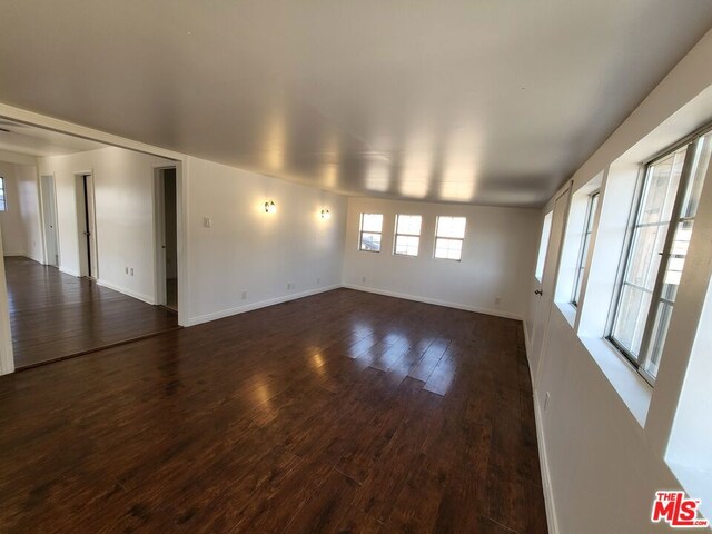 spare room with dark wood-type flooring